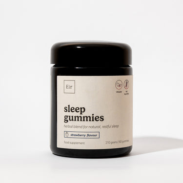 Black jar of Eir Health's vegan sleep gummies in strawberry flavor. Label shows Eir logo and vegan/gluten-free certifications. Contains 60 gummies, 210 grams total.