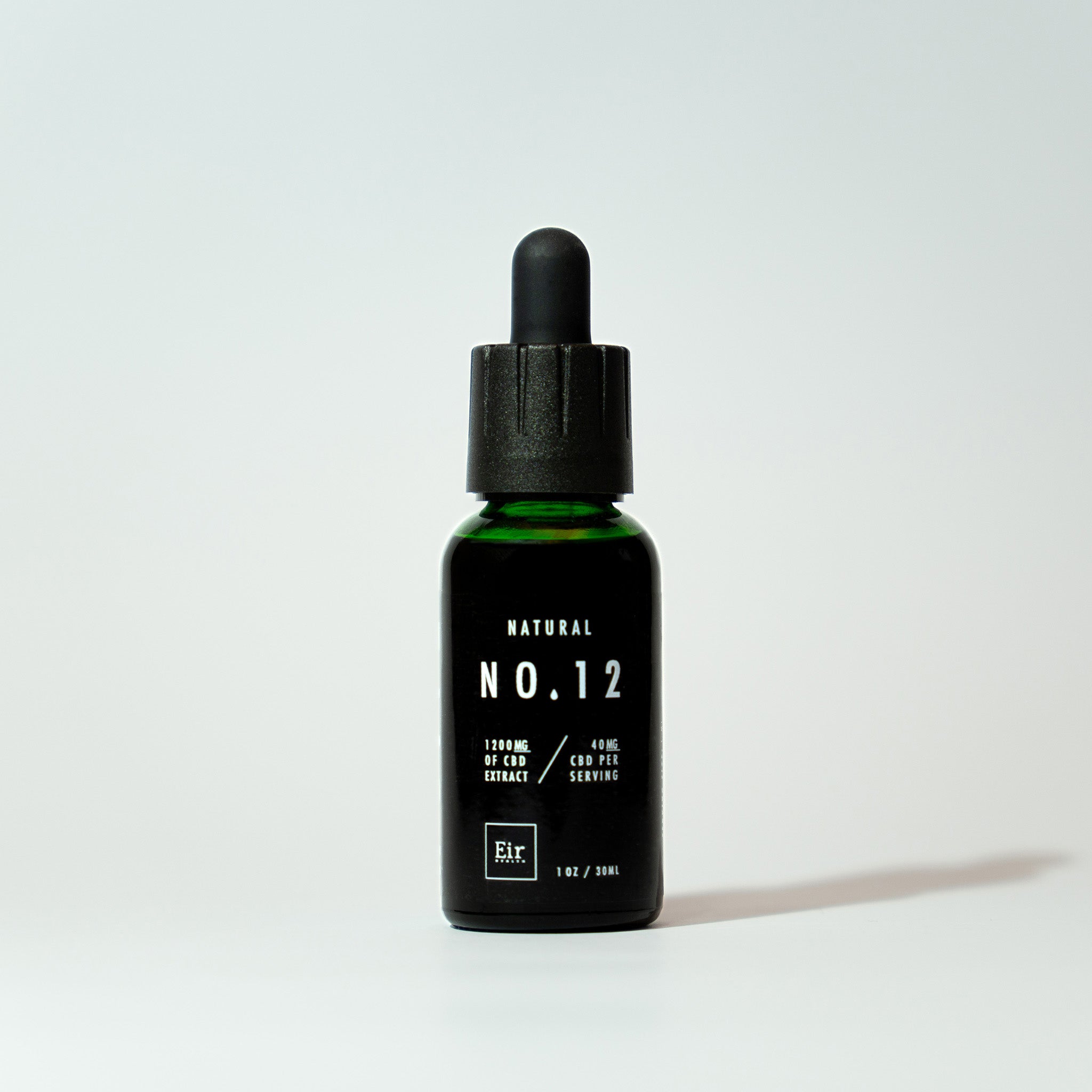 A green bottle of Eir Natural No. 12 oil with a black dropper, labeled with information of 1200 mg CBD, set against a uniform white background.