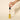 Dłoń trzymająca zakraplacz z olejkiem CBD 'NO. 9 Focus' nad żółtą butelką marki Eir, kropla oleju zwisa nad otwartym wieczkiem, na neutralnym tle.